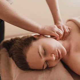 Therapist performing a gentle neck massage to relieve tension and stiffness at Wellspring Therapy in Baton Rouge, LA