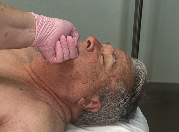 Therapist performing TMJ therapy to relieve jaw tension in Baton Rouge, LA